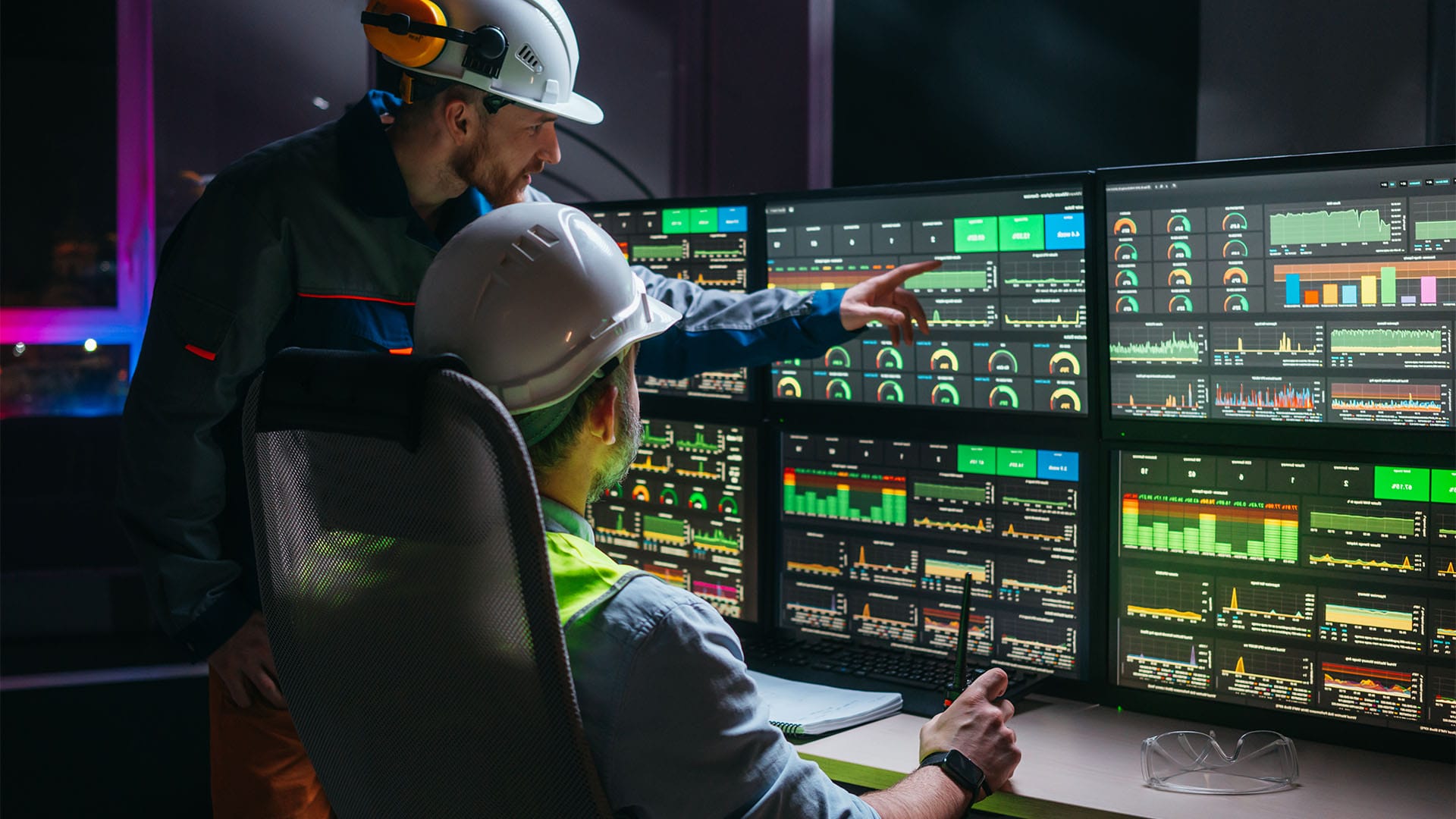 Lead engineer and factory supervisor analyzing data from an industrial AI system