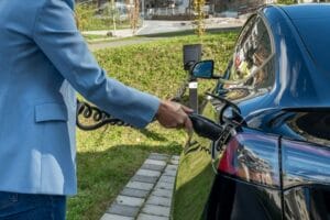 A person charging an electric car