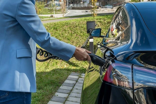 A person charging an electric car
